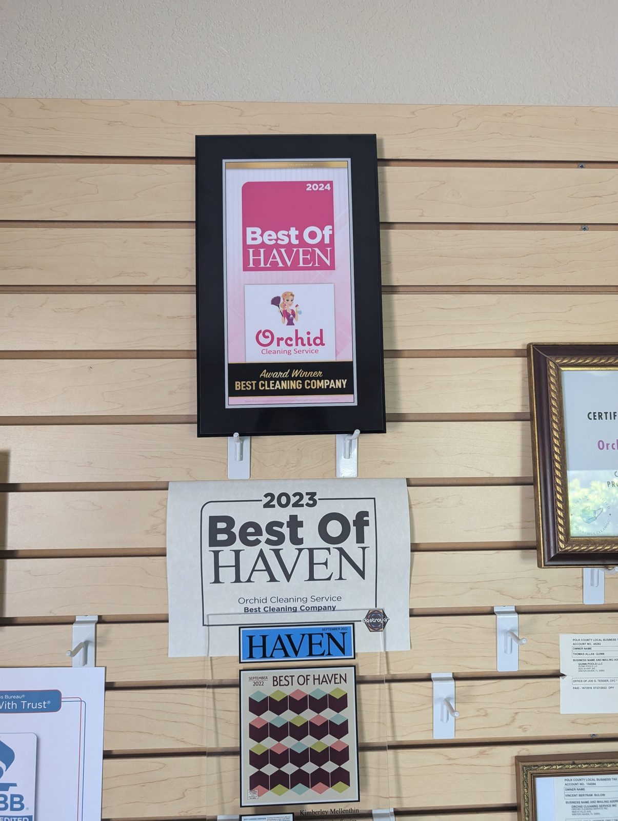 Orchid Cleaning Service's office wall of Best of Haven awards from 2022, 2023 and 2024 alongside its BBB accreditation