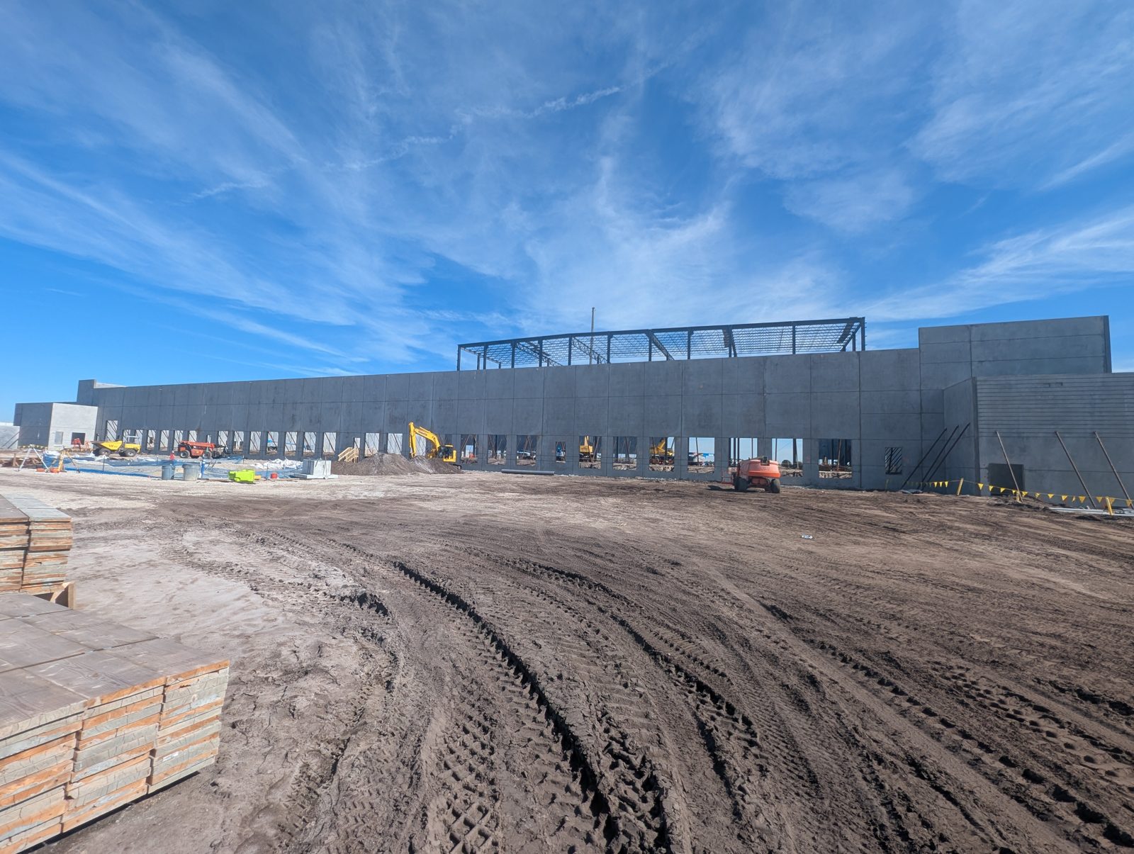 A large commercial distribution building under construction in Polk County, tilt-wall panels up and structural steel going in
