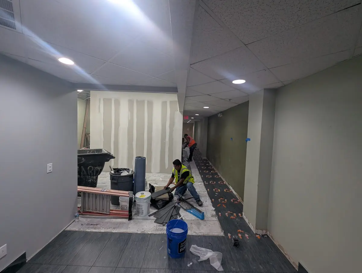 A commercial corridor mid-renovation, at the stage Orchid Cleaning handles post-construction cleanup