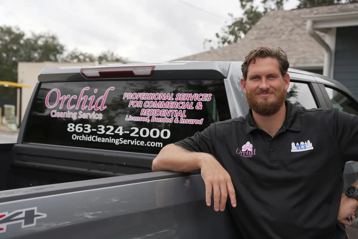 Joey Maher, owner of Orchid Cleaning Service, in Bartow with the branded company truck
