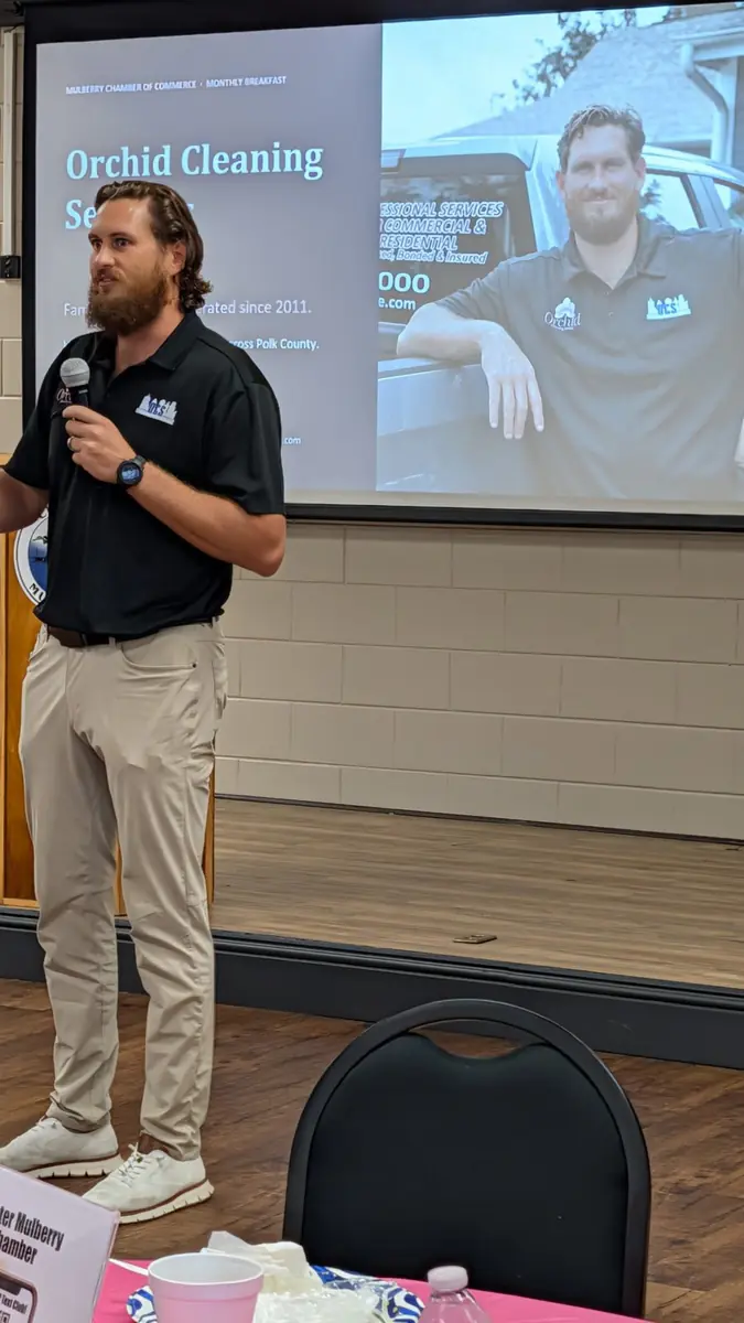 Joey Maher, owner of Orchid Cleaning Service, speaking at the Greater Mulberry Chamber of Commerce monthly breakfast in September 2026