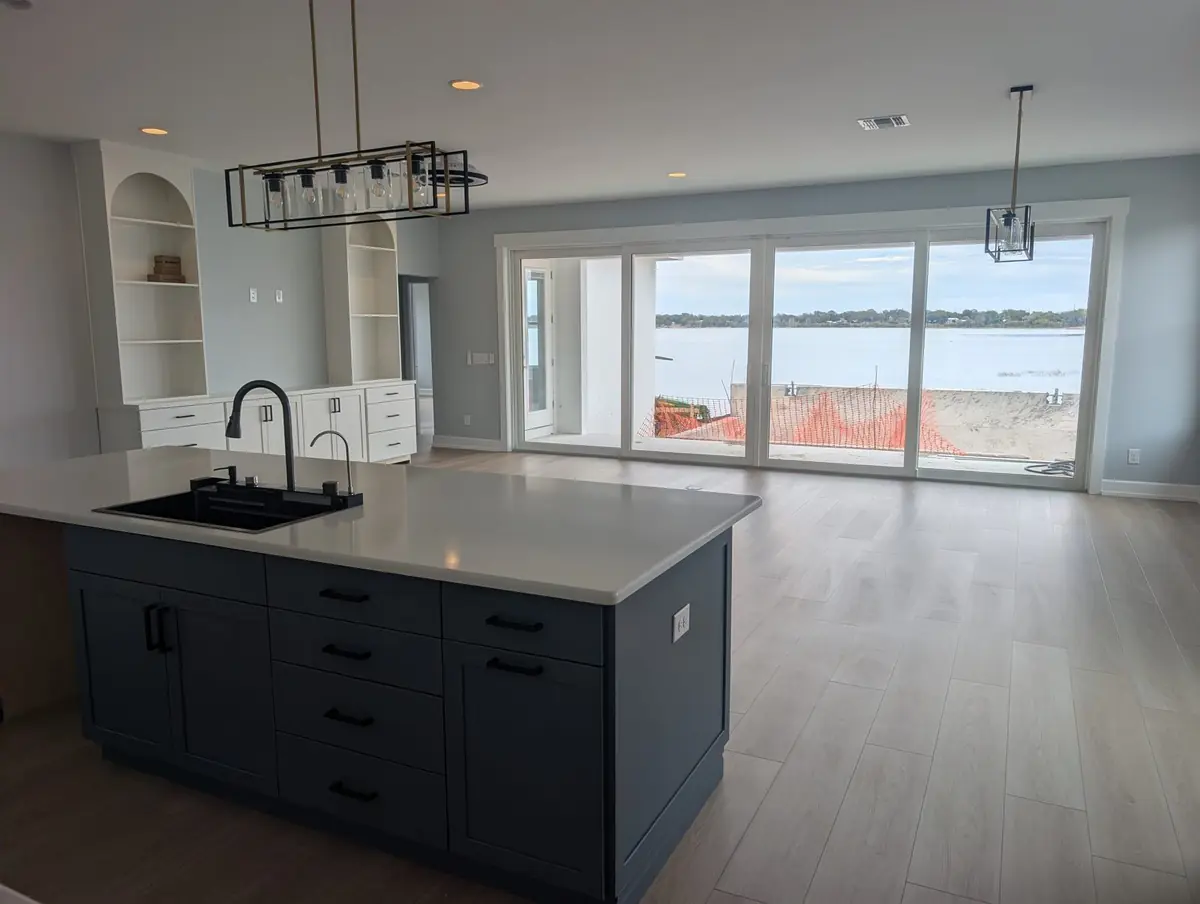 The finished kitchen and lake-view living space of a new lakefront home after an Orchid post-construction clean