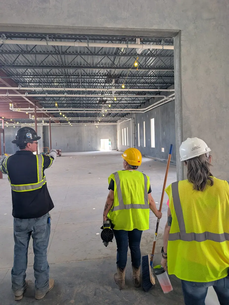An Orchid Cleaning crew being briefed by the general contractor inside a building under construction