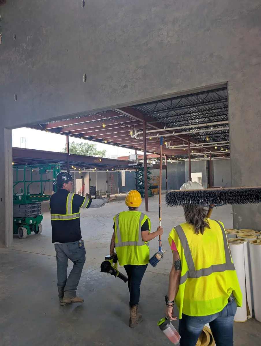 Orchid Cleaning crew walking the unfinished interior of the Winter Haven Recreation & Cultural Center with the general contractor