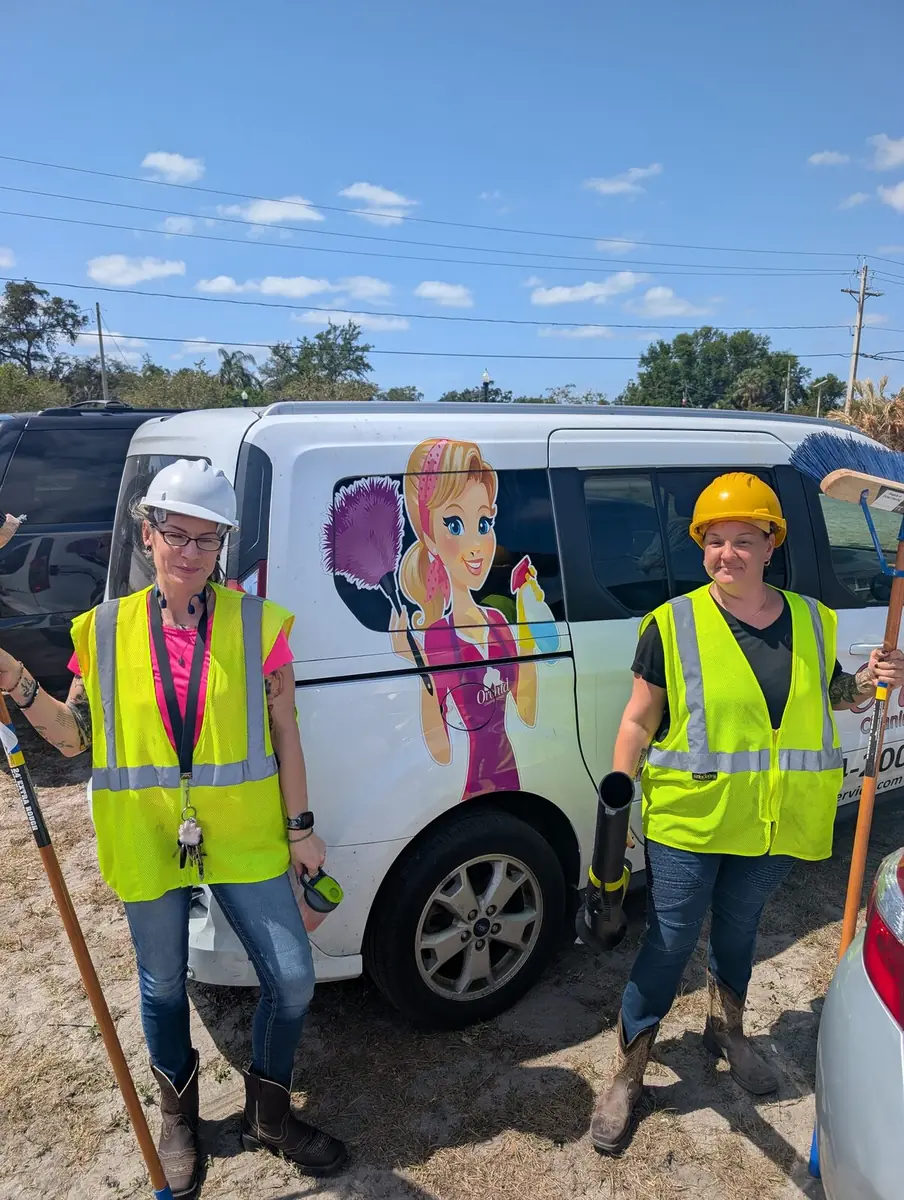 Orchid Cleaning Service crew in safety vests and hard hats at a commercial job site