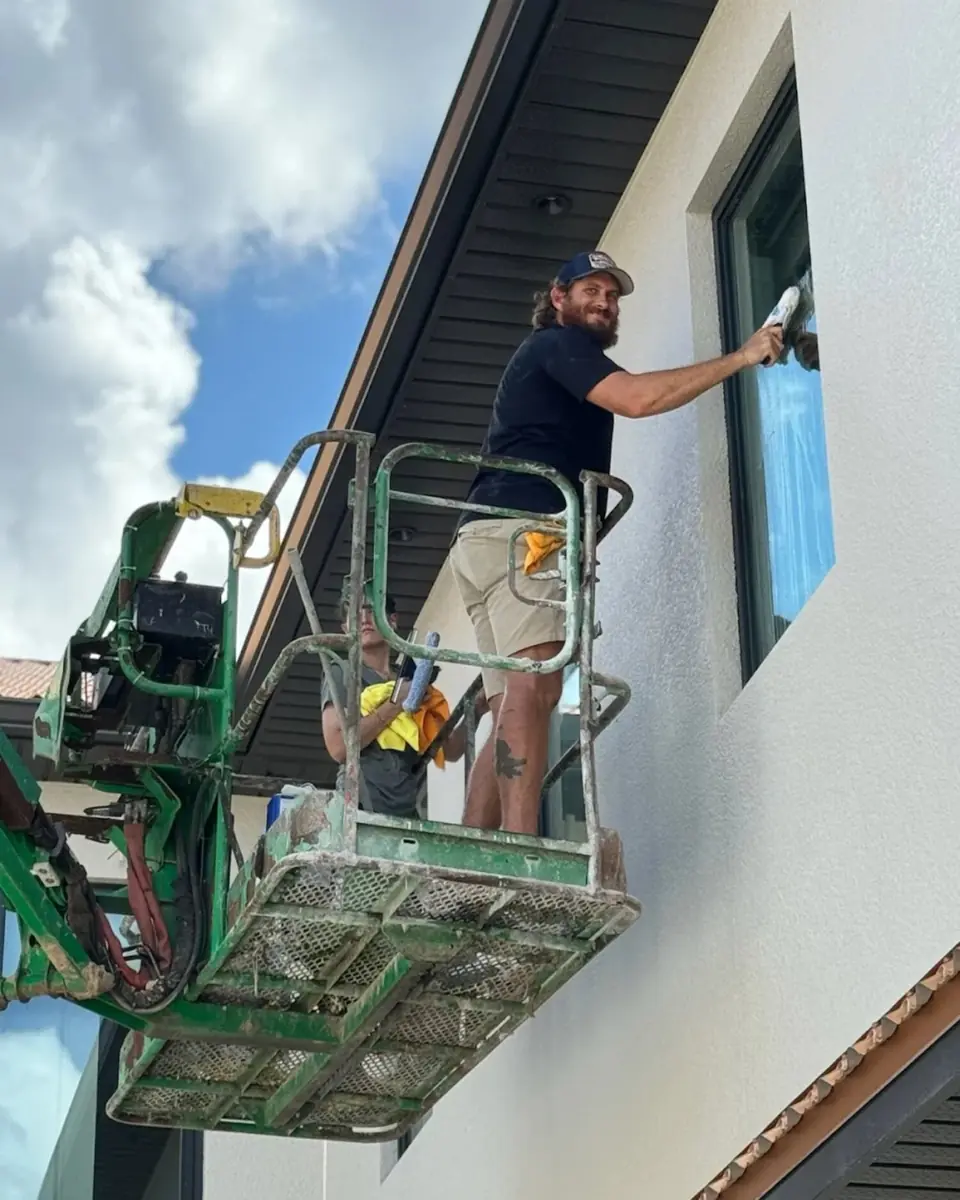 Orchid Cleaning crew on a boom lift cleaning second-story exterior windows